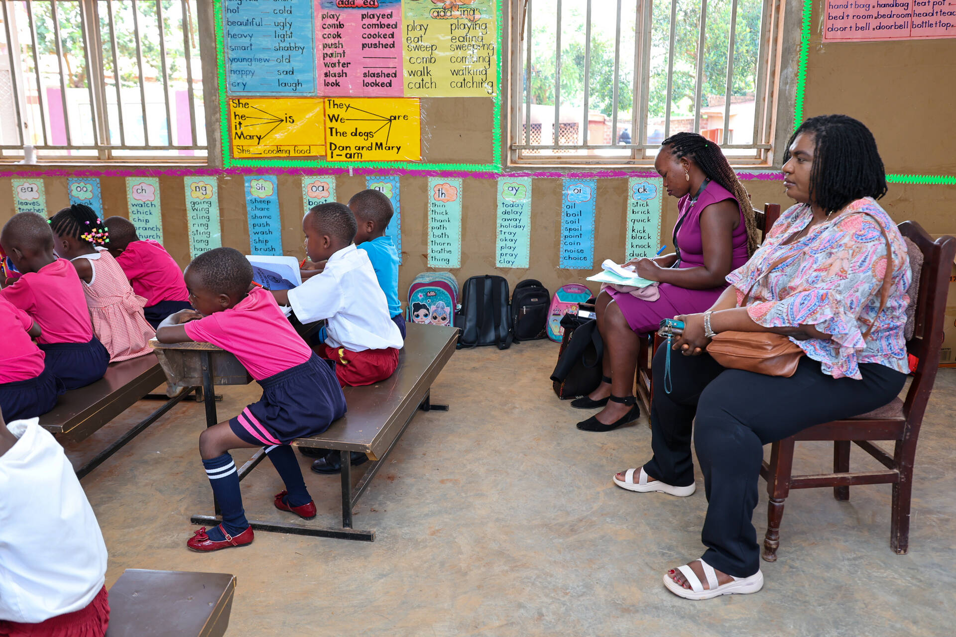Mary observing a classroom activity in Uganda. Photo Credit: Jason Amoo/Opportunity International